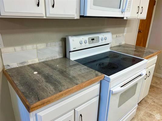 404 N 1st E, Grace, ID 83241 - kitchen featuring white cabinetry and white appliances
