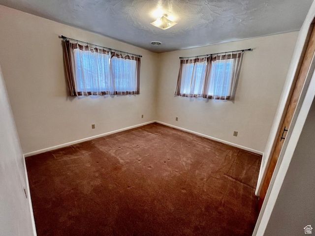 404 N 1st E, Grace, ID 83241 - unfurnished bedroom featuring baseboards, visible vents, carpet floors, and a textured ceiling