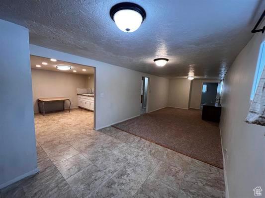 404 N 1st E, Grace, ID 83241 - finished basement with baseboards, carpet flooring, and a textured ceiling