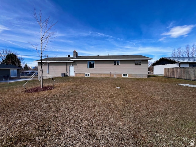 404 N 1st E, Grace, ID 83241 - rear view of property featuring a chimney, fence, and a yard