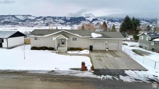 404 N 1st E, Grace, ID 83241 - ranch-style home with driveway, an attached garage, fence, and a mountain view