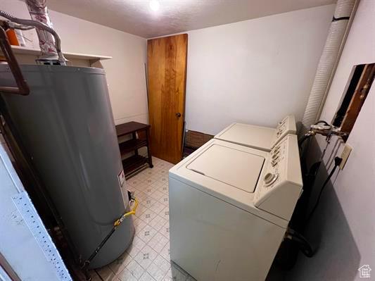 404 N 1st E, Grace, ID 83241 - laundry room featuring independent washer and dryer, laundry area, light floors, and gas water heater