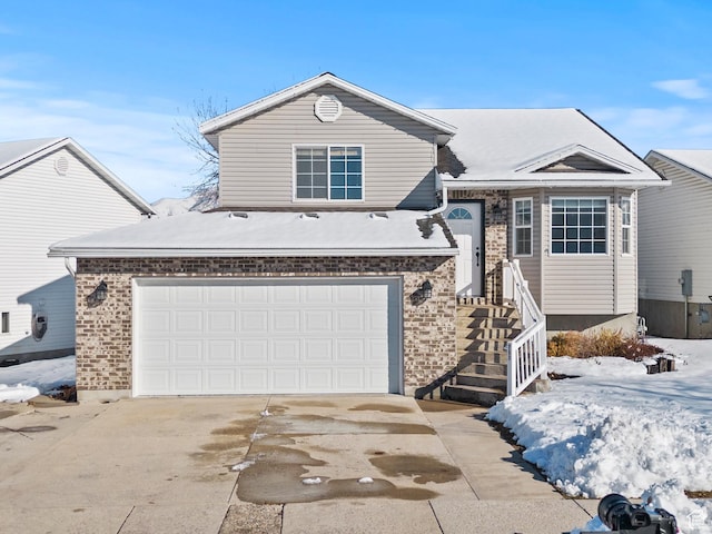view of front facade featuring concrete driveway and brick siding