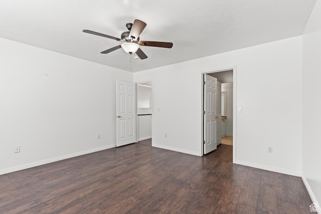 257 Rosewood Cir, Logan, UT 84321 - unfurnished bedroom with dark wood-style floors, ceiling fan, and baseboards