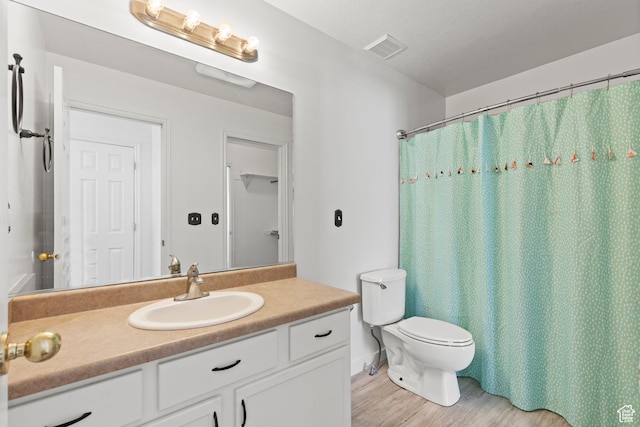 257 Rosewood Cir, Logan, UT 84321 - bathroom featuring toilet, wood finished floors, vanity, visible vents, and a shower with curtain