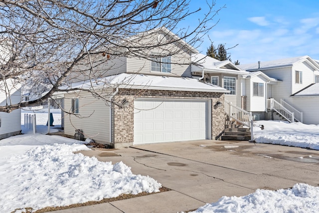 257 Rosewood Cir, Logan, UT 84321 - view of front of property featuring brick siding, driveway, and an attached garage
