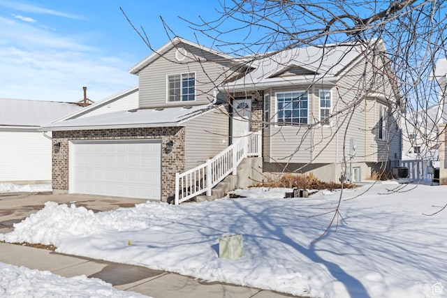 257 Rosewood Cir, Logan, UT 84321 - view of front of home featuring a garage and brick siding