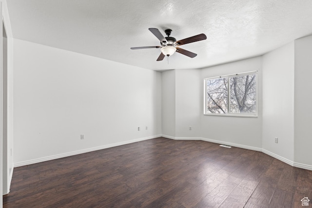 257 Rosewood Cir, Logan, UT 84321 - empty room featuring a textured ceiling, dark wood-type flooring, visible vents, a ceiling fan, and baseboards