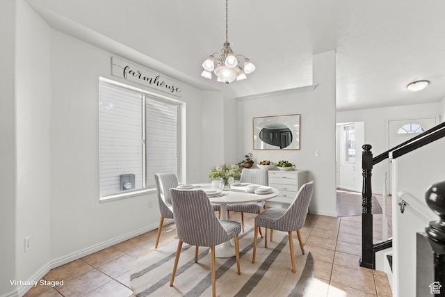 257 Rosewood Cir, Logan, UT 84321 - dining area with light tile patterned floors, baseboards, and a notable chandelier