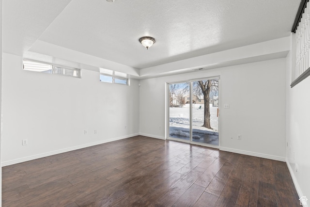 257 Rosewood Cir, Logan, UT 84321 - unfurnished room with a textured ceiling, baseboards, and dark wood-style flooring