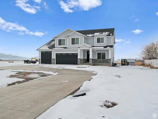 8345 W 11050 N, Tremonton, UT 84337 - view of front of home with fence, stone siding, a garage, and concrete driveway