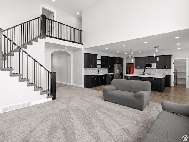 8345 W 11050 N, Tremonton, UT 84337 - living room with visible vents, baseboards, recessed lighting, stairway, and arched walkways
