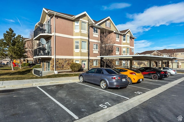 3842 S Clare Dr Unit D-1, West Valley City, UT 84119 - view of property with covered and uncovered parking