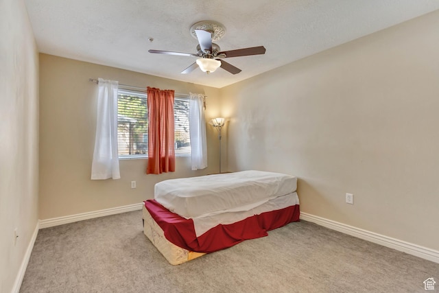 3842 S Clare Dr Unit D-1, West Valley City, UT 84119 - bedroom with a ceiling fan, light carpet, a textured ceiling, and baseboards