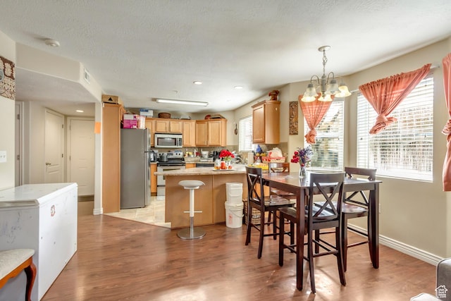3842 S Clare Dr Unit D-1, West Valley City, UT 84119 - dining space featuring light wood-style floors, a textured ceiling, visible vents, and a notable chandelier