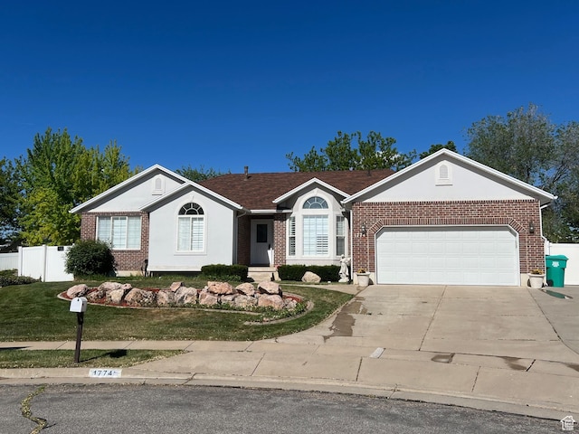 single story home featuring concrete driveway, an attached garage, and brick siding