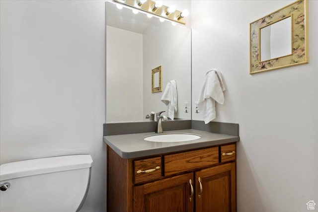 bathroom featuring toilet and vanity