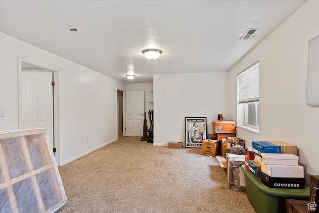 game room with carpet floors, a textured ceiling, and baseboards