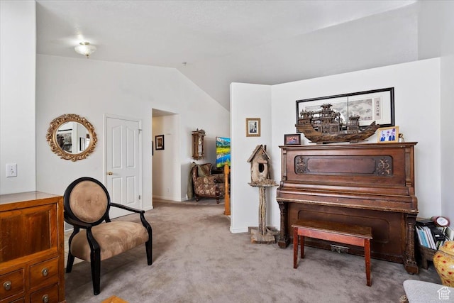 living area featuring vaulted ceiling, carpet, and baseboards