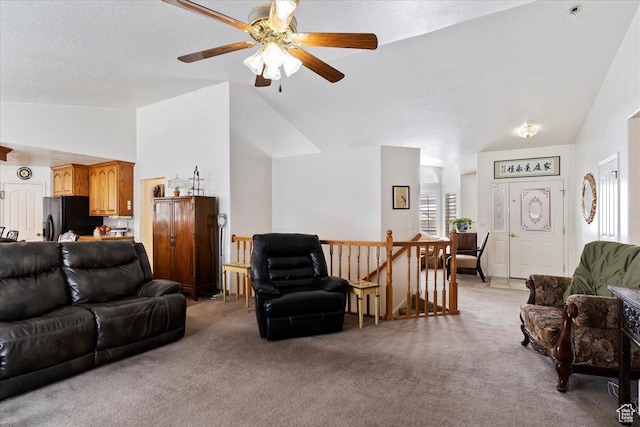 living room with lofted ceiling, light colored carpet, and a ceiling fan