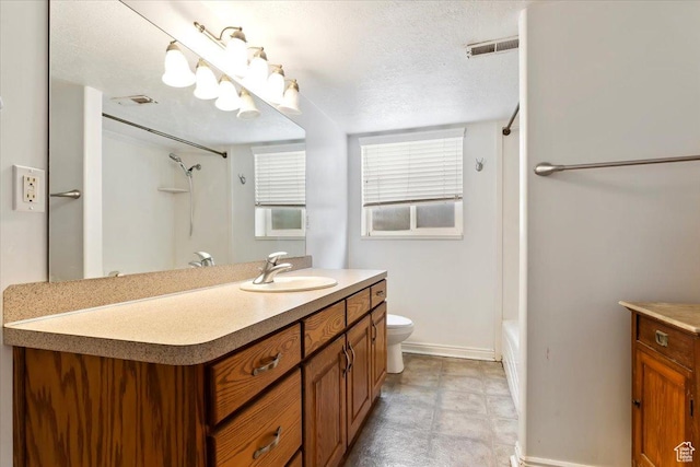 full bath with baseboards, toilet, vanity, a textured ceiling, and tub / shower combination