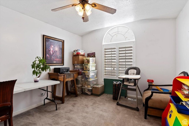 office featuring a ceiling fan, carpet, and a textured ceiling