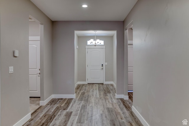 4386 W 3800 S, West Haven, UT 84401 - foyer entrance with light wood-style flooring, a chandelier, and baseboards