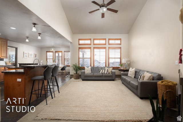 living room with ceiling fan, high vaulted ceiling, and plenty of natural light