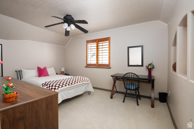 bedroom featuring light carpet, vaulted ceiling, a textured ceiling, and baseboards