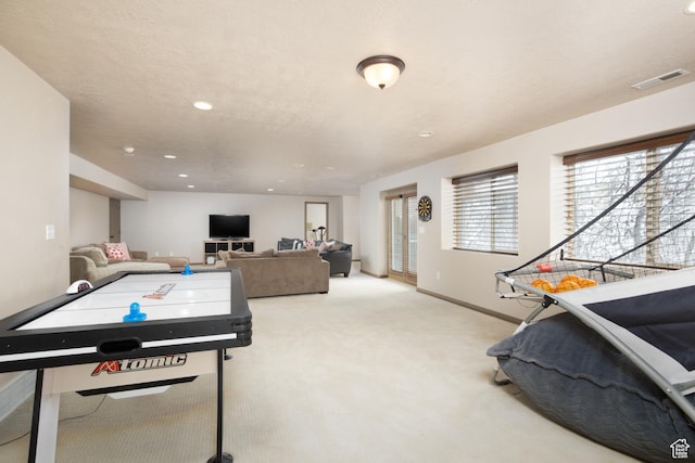 playroom featuring recessed lighting, light colored carpet, visible vents, a textured ceiling, and baseboards
