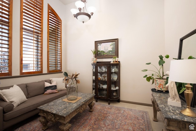 living room featuring baseboards and light colored carpet