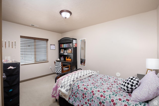 carpeted bedroom with visible vents and baseboards