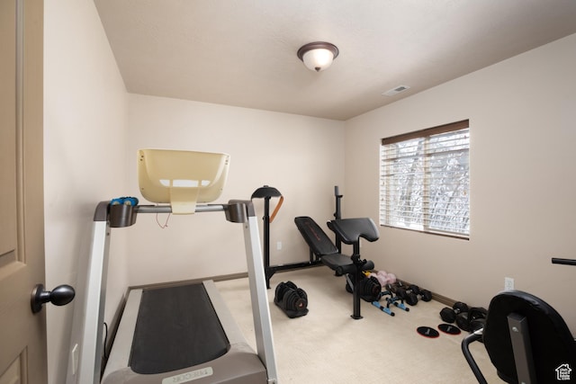 exercise area featuring carpet flooring, visible vents, and baseboards