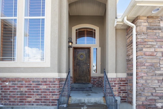 entrance to property with stone siding and brick siding
