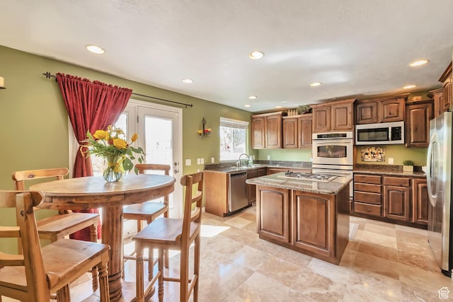 8783 N Franklin Dr, Eagle Mountain, UT 84005 - kitchen featuring stone countertops, recessed lighting, stainless steel appliances, a sink, and a center island
