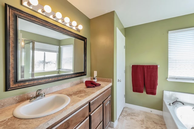 8783 N Franklin Dr, Eagle Mountain, UT 84005 - full bathroom with a garden tub, vanity, and baseboards