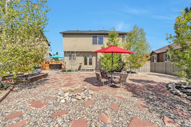 8783 N Franklin Dr, Eagle Mountain, UT 84005 - rear view of property featuring entry steps, a patio, a fenced backyard, and stucco siding