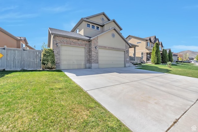 8783 N Franklin Dr, Eagle Mountain, UT 84005 - traditional-style home featuring driveway, stone siding, a residential view, and fence