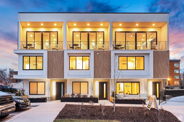 view of front of property featuring a balcony and stucco siding