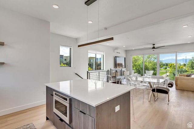 kitchen with a wealth of natural light, open floor plan, a center island, and modern cabinets