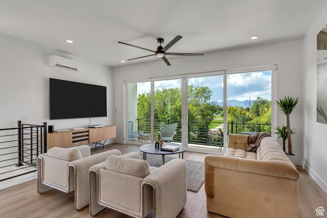 living room with a wall mounted air conditioner, wood finished floors, a ceiling fan, and recessed lighting