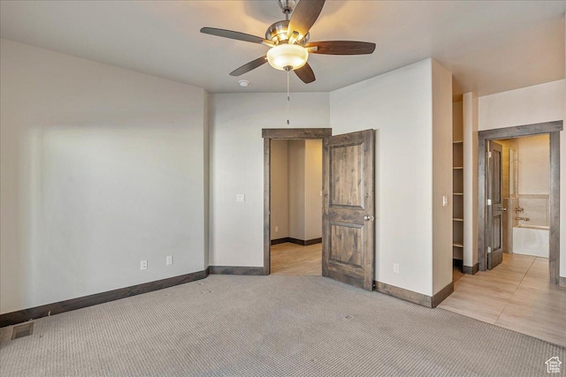 14408 N Buck Horn Trl N Unit 52C, Kamas, UT 84036 - unfurnished bedroom with baseboards, visible vents, a ceiling fan, and light colored carpet