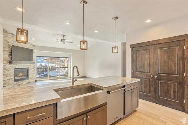 14408 N Buck Horn Trl N Unit 52C, Kamas, UT 84036 - kitchen featuring light wood finished floors, dishwasher, light stone counters, hanging light fixtures, and a sink