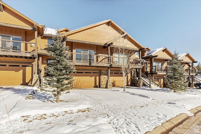 14408 N Buck Horn Trl N Unit 52C, Kamas, UT 84036 - view of front of home featuring a balcony, an attached garage, stairs, and board and batten siding