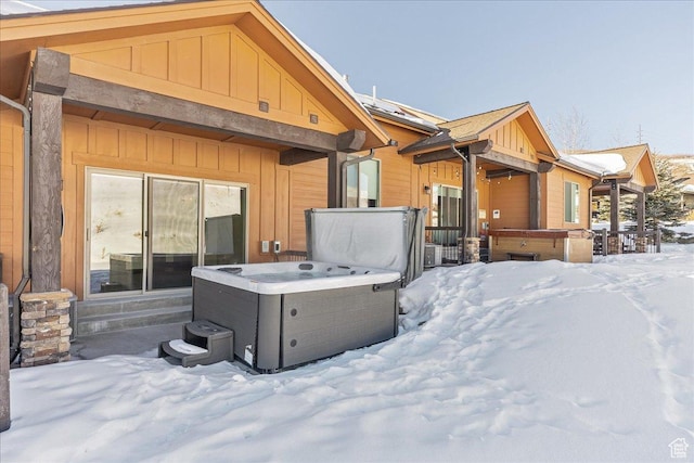 14408 N Buck Horn Trl N Unit 52C, Kamas, UT 84036 - snow covered rear of property featuring board and batten siding and a hot tub