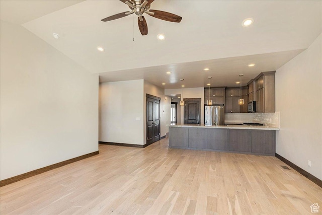 14408 N Buck Horn Trl N Unit 52C, Kamas, UT 84036 - kitchen featuring light wood-style flooring, dark brown cabinetry, a peninsula, light countertops, and appliances with stainless steel finishes