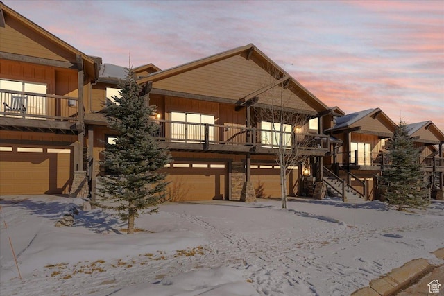 14408 N Buck Horn Trl N Unit 52C, Kamas, UT 84036 - view of front of home featuring a balcony, a garage, stairway, and board and batten siding