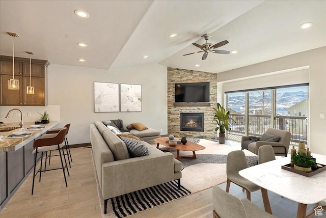 14408 N Buck Horn Trl N Unit 52C, Kamas, UT 84036 - living area with a stone fireplace, light wood-style flooring, recessed lighting, baseboards, and vaulted ceiling