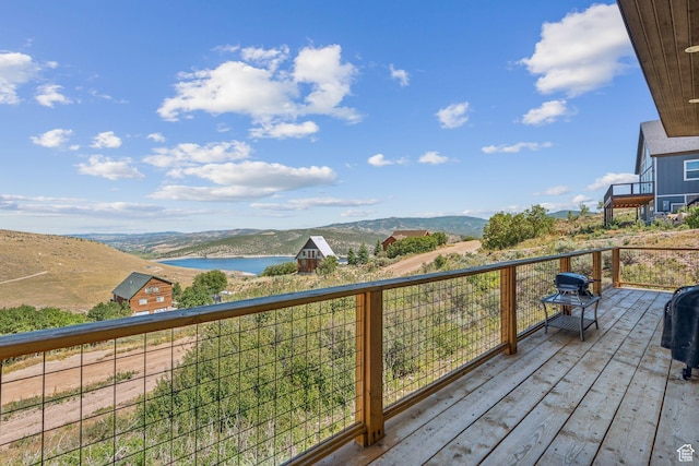 deck featuring grilling area and a water and mountain view