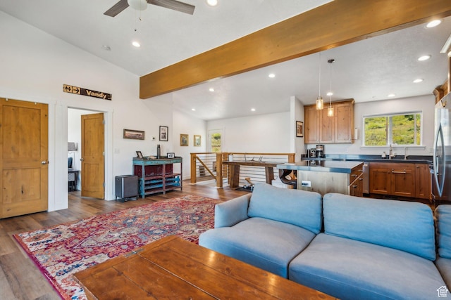 living area featuring high vaulted ceiling, dark wood finished floors, beam ceiling, and recessed lighting